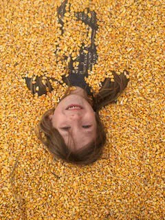 Children playing in the corn box